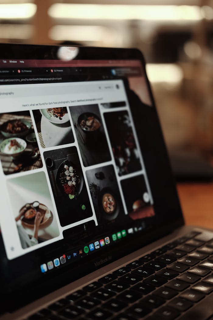 services-04 Laptop showing food photography editing software interface in a cozy setting.